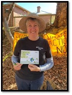 Photo of Cathy Levett holding a Changing the World flyer
